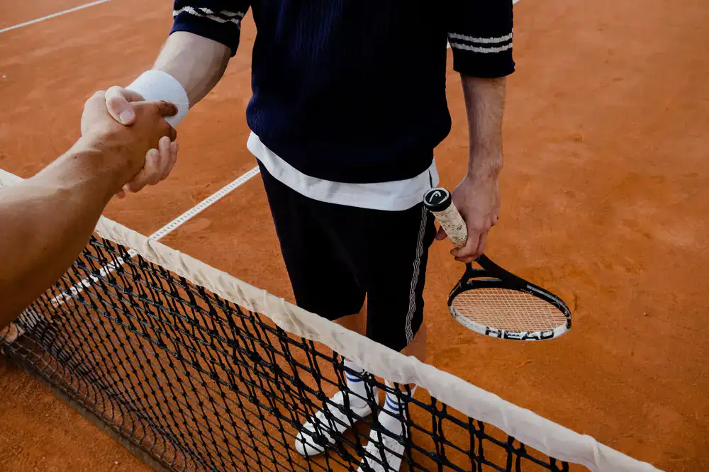 Two competitors shaking hands before a bracket match